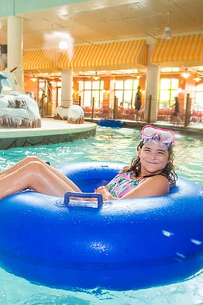 Girl in tube in a lazy river at an indoor waterpark