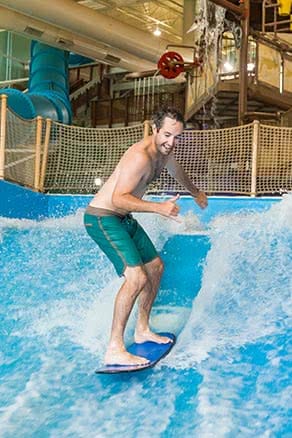 Man surfing at Avalanche Bay water park 