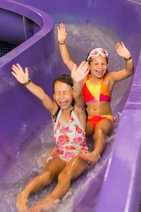 Young girls on slide at waterpark