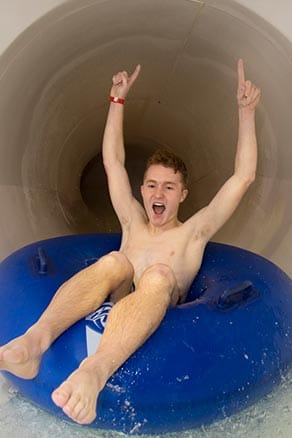 Boy in tube on waterslide