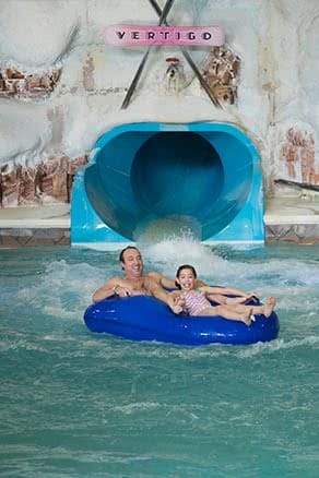 Father & daughter in tube at bottom of waterslide